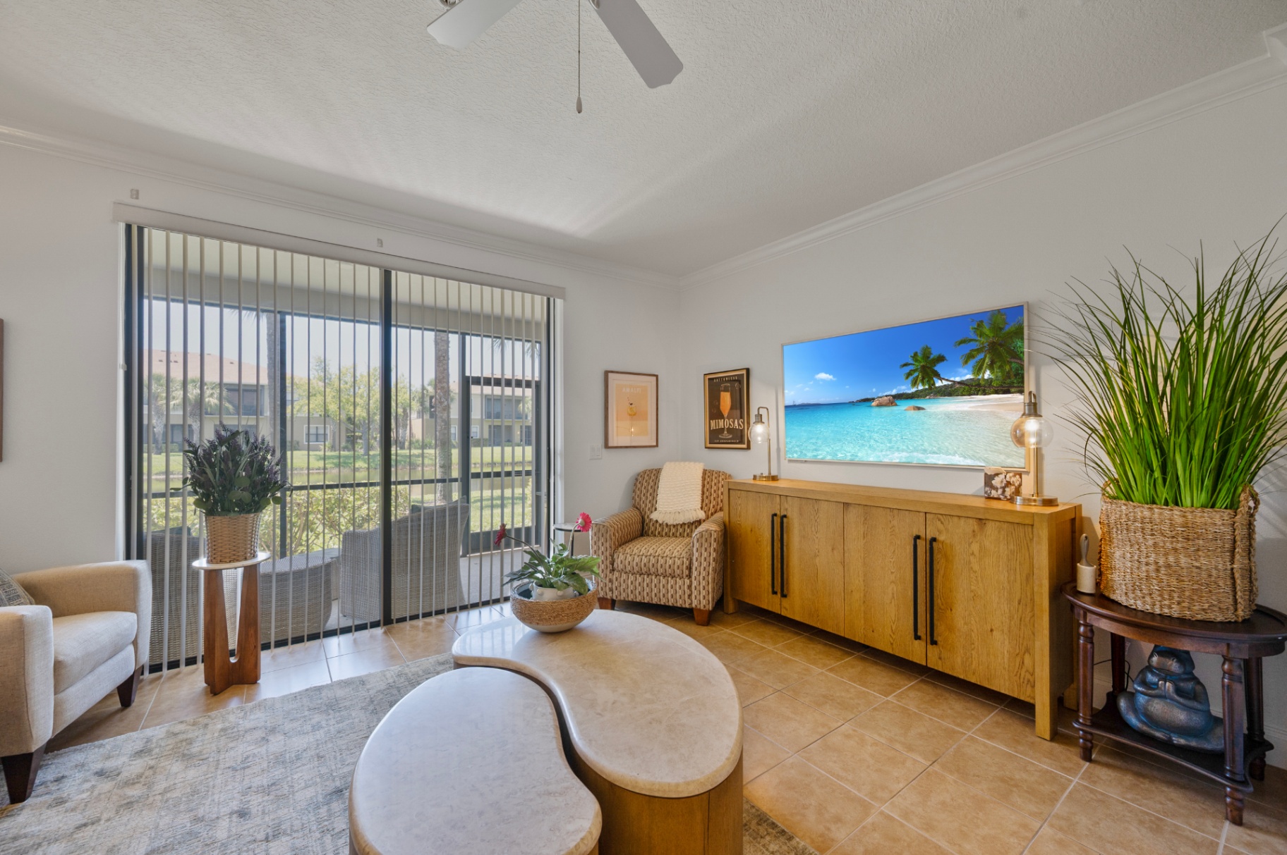 Living room seating area with pond-facing doors to the screened lanai