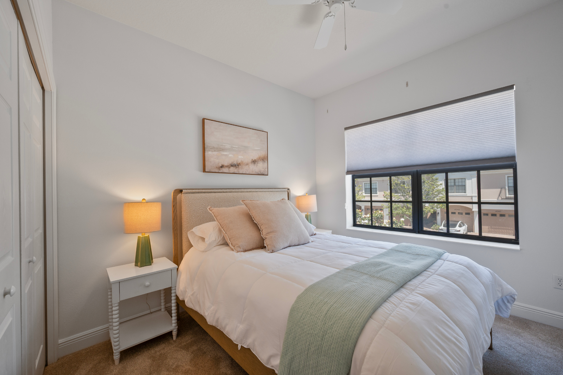Third bedroom with soft neutral palette and bright window