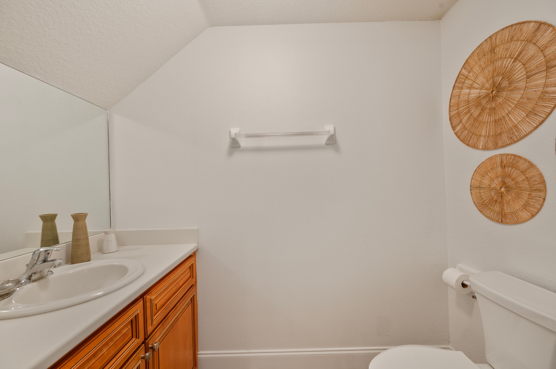 Ground-floor powder room with vanity and wall mirror