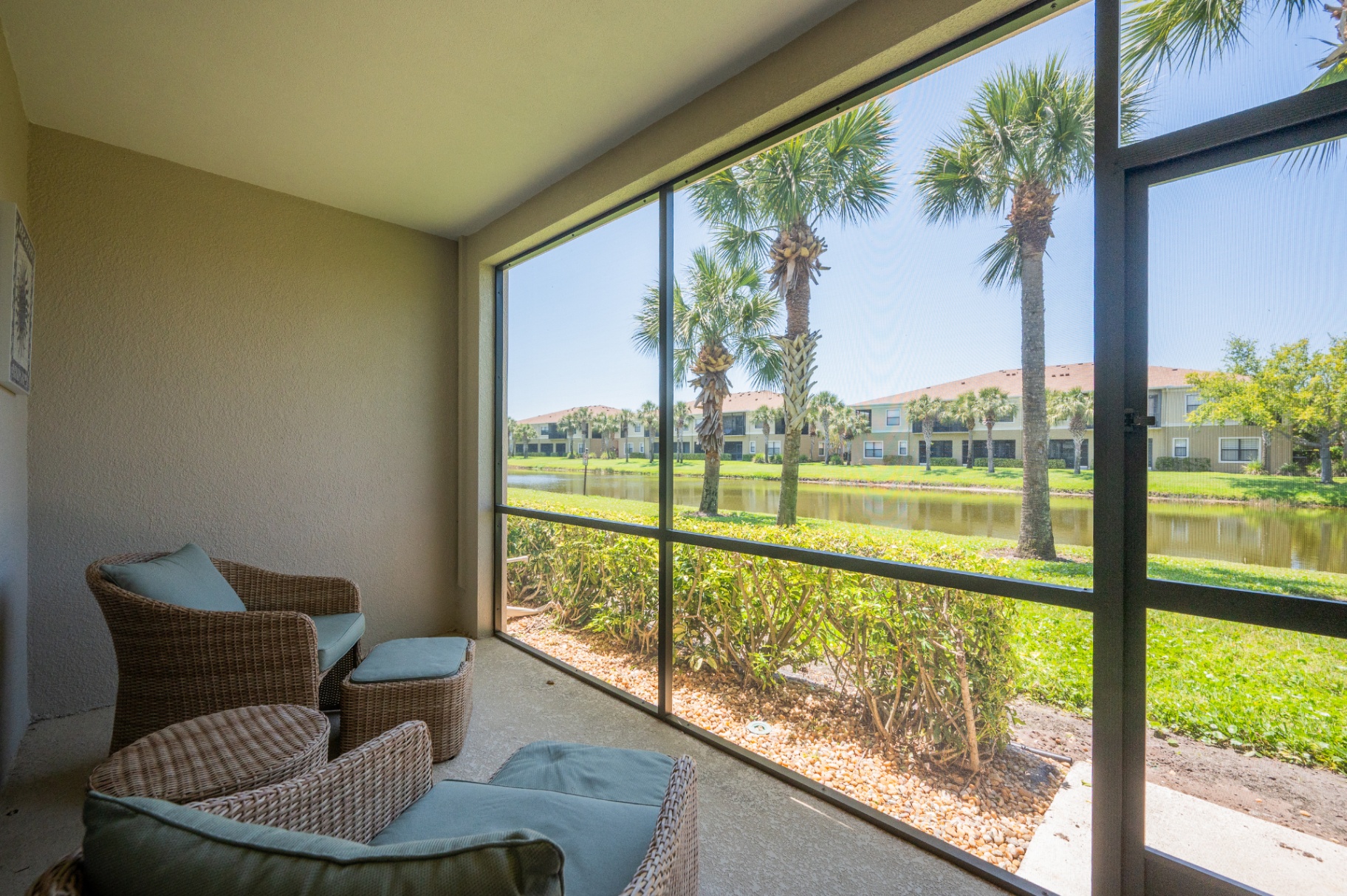 Screened lanai view looking directly over the community pond